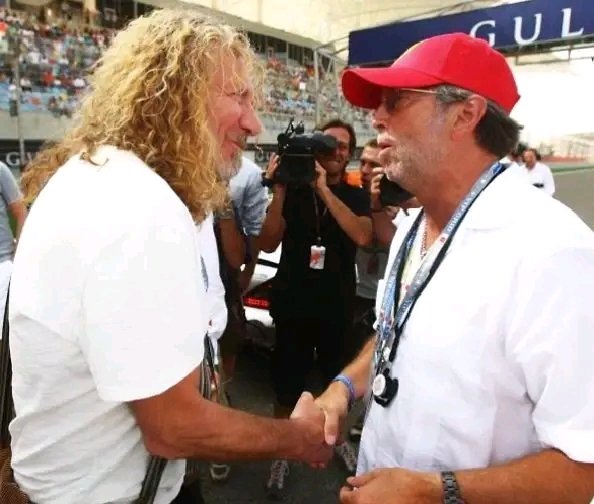 Robert Plant and Eric Clapton Share a Moment on the Grid at the 2009 Bahrain Grand Prix — A Collision of Music Royalty and Motorsport Majesty